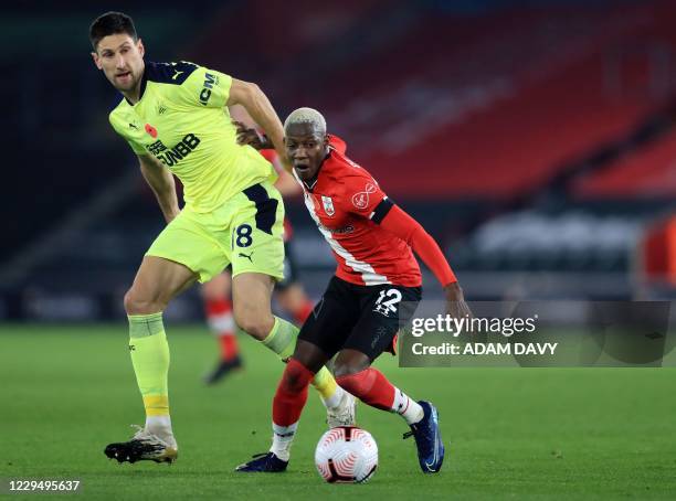 Southampton's Malian midfielder Moussa Djenepo vies for the ball against Newcastle United's Argentinian defender Federico Fernandez during the...
