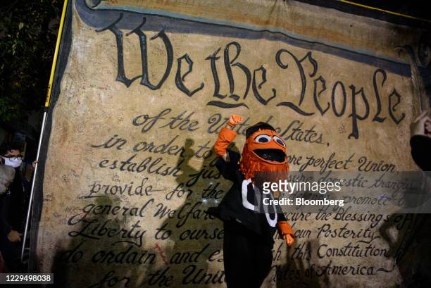 Demonstrator dressed as Philadelphia Flyers mascot Gritty raises their fist during the 2020 Presidential election in Philadelphia, Pennsylvania,...