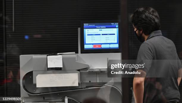 Officials count ballots of 2020 United States Presidential Election at the Mecklenburg County Board of Elections office in Charlotte, North Carolina,...