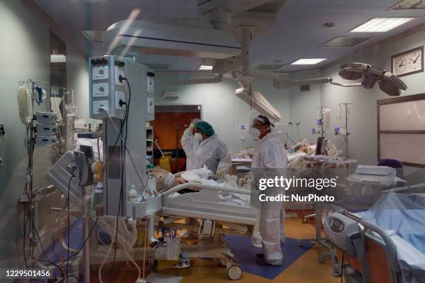 Doctorts check the condition of a patient inside the intensive care unit in the COVID 19 department at the Istituto Clinico Casalpalocco hospital in...