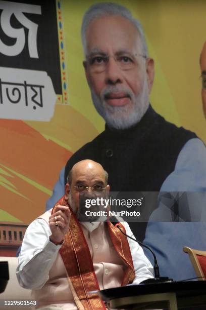 Union home minister Amit Shah address at the Meet the Press , Back side India Prime Minister Narendra Modi big Photos during Shah two-day visit to...