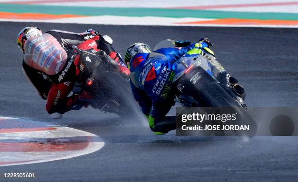 Ducati Team Italian driver Andrea Dovizioso rides ahead of Team SUZUKI ECSTAR Spanish driver Joan Mir during the fourth free practice session of the...