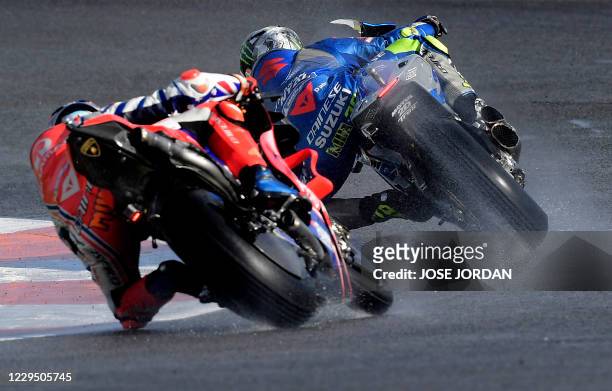 Team SUZUKI ECSTAR Spanish driver Joan Mir rides ahead of Pramac Racing Australian driver Jack Miller during the fourth free practice session of the...