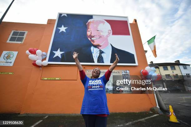 Beryl McCrainey Slevin from California and who voted using a mail in ballot stands in front of the mural of Joe Biden on November 7, 2020 as locals...