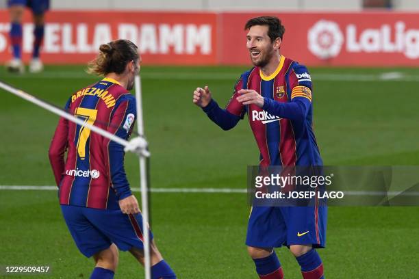 Barcelona's French midfielder Antoine Griezmann celebrates his goal with Barcelona's Argentine forward Lionel Messi during the Spanish League...