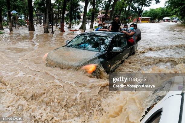 People affected by Eta is transported in a truck through a flooded main road on November 6, 2020 in Cortes, Honduras. Eta entered Nicaragua as a...