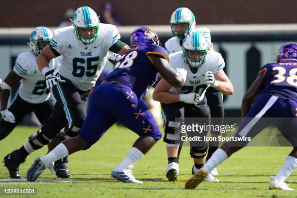 Tulane Green Wave Offensive Lineman Timothy Shafter blocks East Carolina Pirates Defensive Tackle Xavier McIver during the first half of the College...