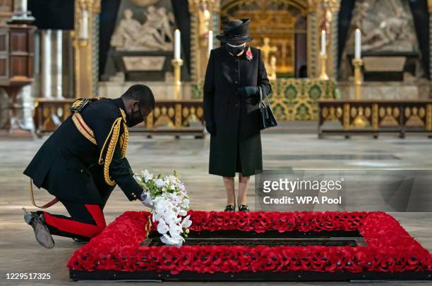 The Queen's Equerry, Lieutenant Colonel Nana Kofi Twumasi-Ankrah, places a bouquet of flowers at the grave of the Unknown Warrior on behalf of Queen...