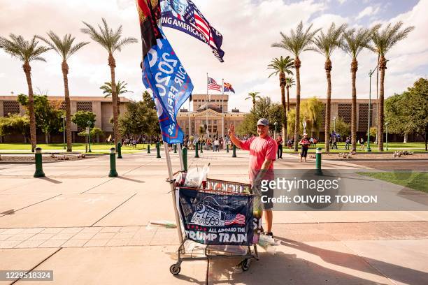 Alan Harrington , from Oregon, came to sell pro Trump flags, as Trump supporters are gathering in front of Arizona State Capitol after the US...