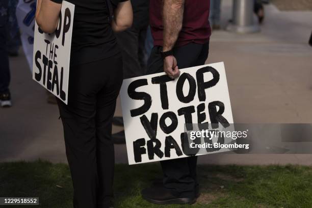 Supporters of U.S. President Donald Trump hold signs at a 'Stop the Steal' protest as President-elect Joe Biden is declared the winner of the U.S....