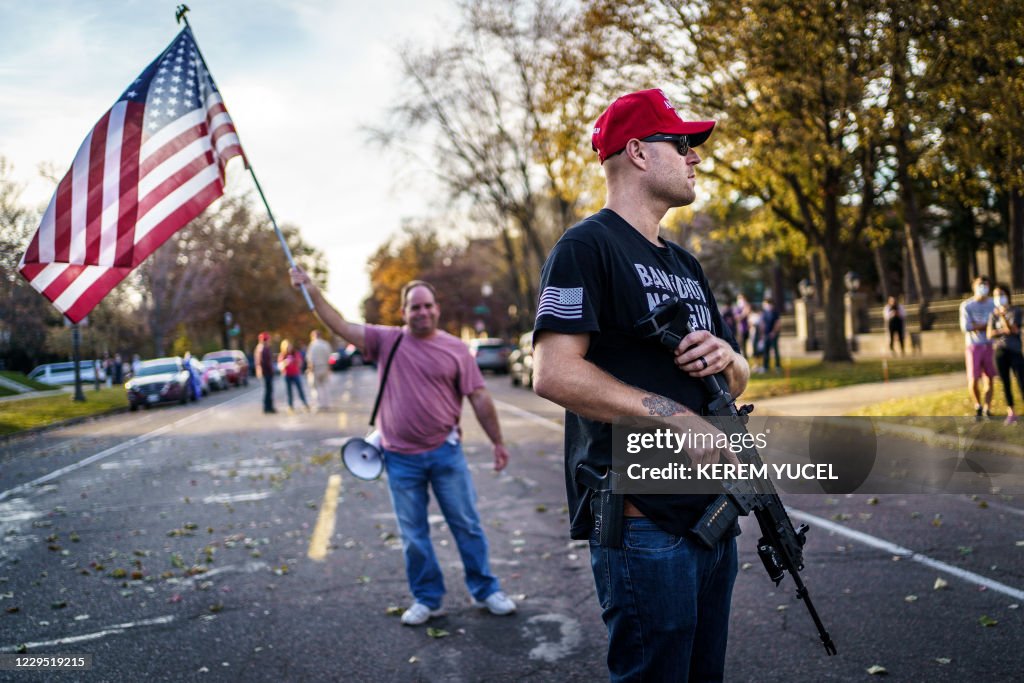 Local Political Rally A supporter of US President Donald Trump keeps a hand on his gun ...
