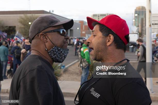 Supporter of U.S. President Donald Trump, right, speaks with a supporter of President-elect Joe Biden at a 'Stop the Steal' protest as...