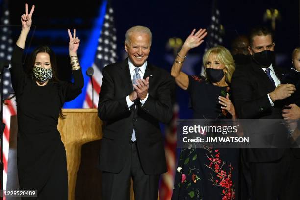 Ashley Biden, daughter of Joe Biden, US President-elect Joe Biden, wife Jill Biden and Hunter Biden salute the crowd after delivering remarks in...