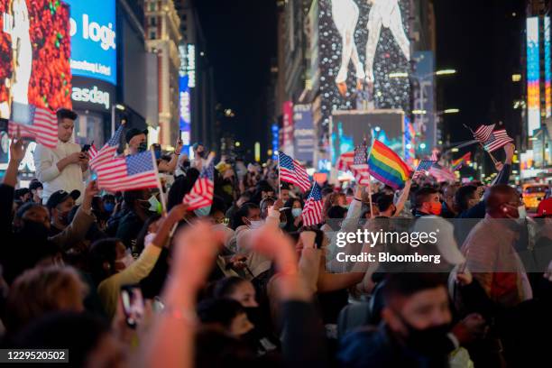 People celebrate as President-elect Joe Biden is declared the winner of the U.S. Presidential election, in New York, U.S., on Saturday, Nov. 7, 2020....