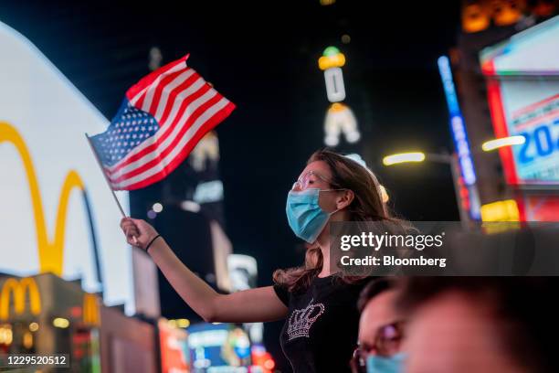 People celebrate as President-elect Joe Biden is declared the winner of the U.S. Presidential election, in New York, U.S., on Saturday, Nov. 7, 2020....