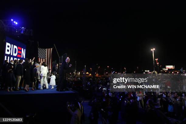 President-elect Joe Biden and family members salutes the crowd after delivering remarks in Wilmington, Delaware, on November 7 after being declared...