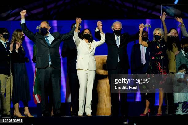 President-elect Joe Biden and Vice President-elect Kamala Harris, stand with their spouses, Dr. Jill Biden and Douglas Emhoff, after addressing the...