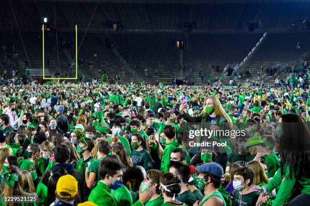 Fans storm the field after the Notre Dame Fighting Irish defeated the Clemson Tigers 47-40 in double overtime at Notre Dame Stadium on November 7,...