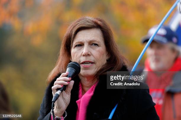 Anon adherent and recent Senate candidate Jo Rae Perkins speaks as supporters of President Donald Trump take part in a rally in Oregonâs State...
