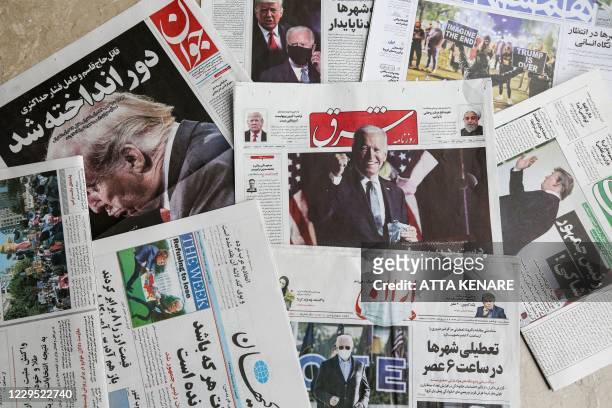 This picture taken on November 8, 2020 in Iran's capital Tehran shows a view of Iranian Farsi newspapers with headlines featuring the 2020 US general...