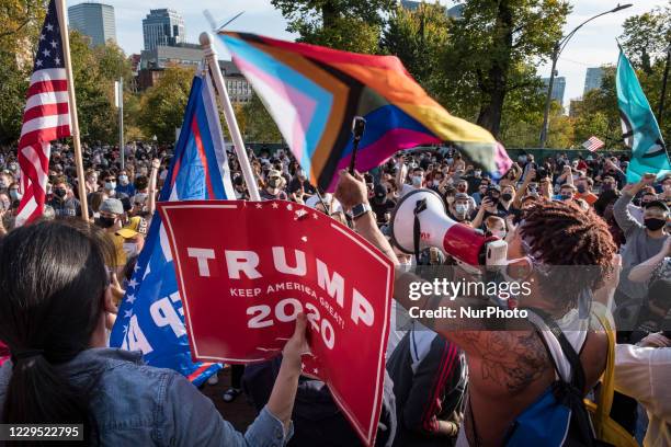 Trump and Biden supporters jostled for space in front of the Massachusetts State House in Boston after hearing the news that Biden was declared the...