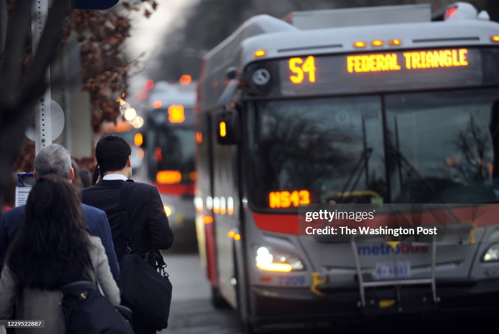 Bus Rider Line Bus riders wait for a bus on 16th Street near U Street going south ...