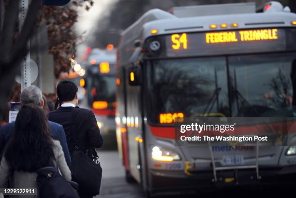 Bus riders wait for a bus on 16th Street near U Street going south towards downtown on 16th Street in Northwest. Many of them encounter problems with...