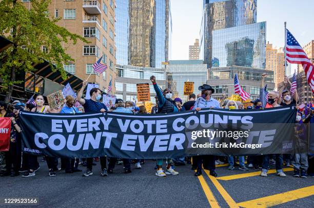 Participants at the front of the march holding a banner reading: "EVERY VOTE COUNTS/COUNT EVERY VOTE". Thousands of New Yorkers joined members of the...