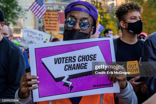 Participant holding a sign at the celebratory march. Thousands of New Yorkers joined members of the Protect the Results: New York City Coalition, a...