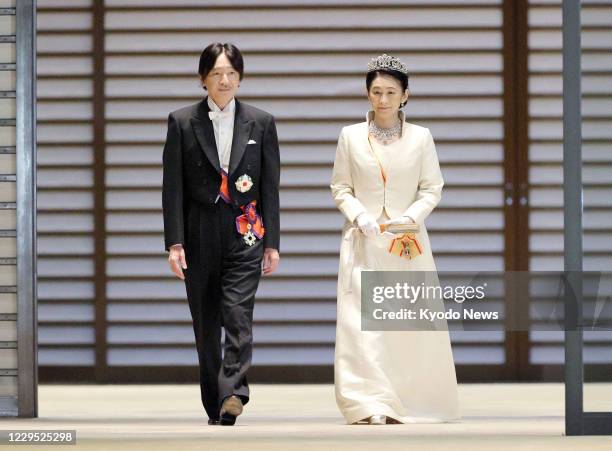 Japanese Crown Prince Fumihito and Crown Princess Kiko are pictured leaving the Imperial Palace in Tokyo on Nov. 8 following day-long rituals for his...