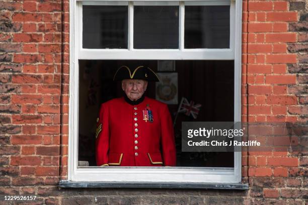 Chelsea Pensioner Peter Cooper, OBE, watches a Remembrance Day service from his window at Royal Hospital Chelsea on November 8, 2020 in London,...