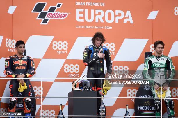 Race winner SKY Racing Team VR46's Italian rider Marco Bezzecchi celebrates on the podium with second placed Red Bull KTM Ajo's Spanish rider Jorge...