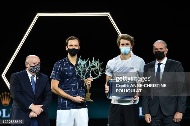 Russia's Daniil Medvedev , flanked by President of the French Tennis Federation Bernard Giudicelli and Director of the Paris Masters tournament Guy...