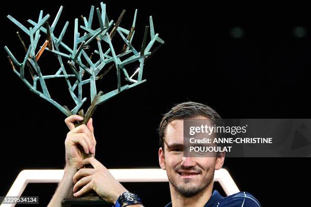 Russia's Daniil Medvedev celebrates with the trophy after winning his men's singles final tennis match against Germany's Alexander Zverev, on day 7...