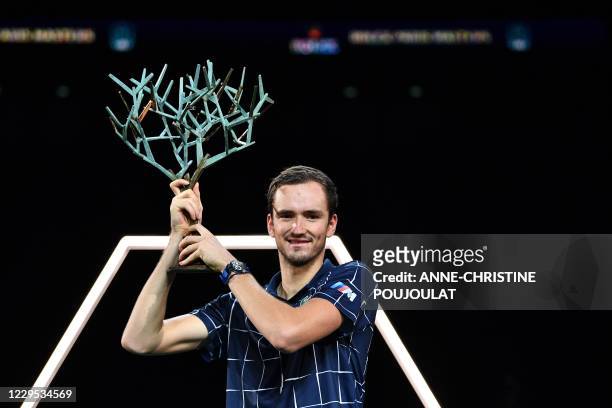 Russia's Daniil Medvedev celebrates with the trophy after winning his men's singles final tennis match against Germany's Alexander Zverev, on day 7...