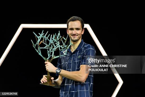 Russia's Daniil Medvedev celebrates with the trophy after winning his men's singles final tennis match against Germany's Alexander Zverev, on day 7...