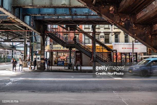 Daily life view of the road and street under the subway railroad air-bridge metal construction of M, J and Z lines near Marcy Ave station, with...