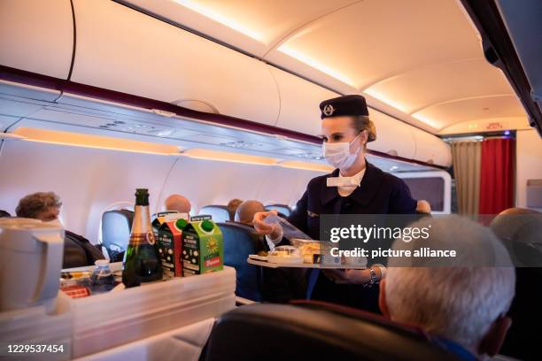 November 2020, Berlin: A flight attendant serves food and beverages on the last scheduled flight of the French airline Air France, which departed...