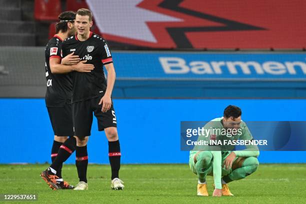 Moenchengladbach's Algerian defender Ramy Bensebaini reacts next Leverkusen's German defender Sven Bender and Leverkusen's Austrian defender...