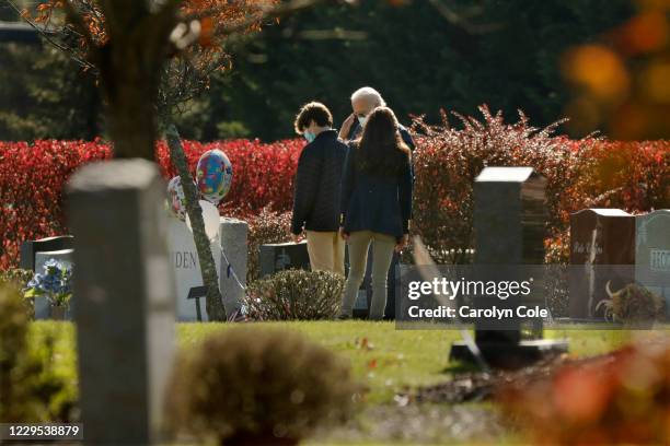 President-elect Joe Biden, center, salutes his son Beau Biden's grave after, attending church at St. Joseph on the Brandywine Roman Catholic Church...