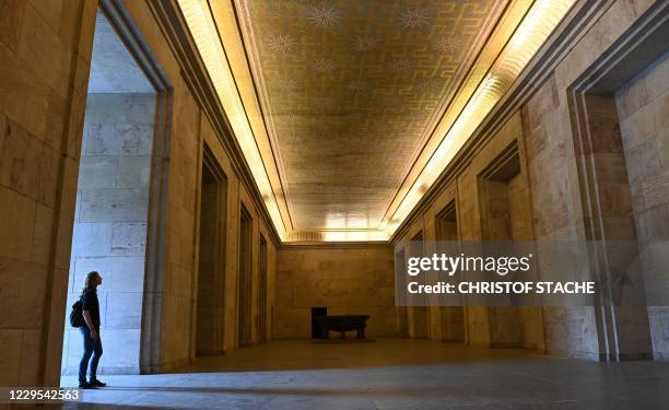 Visitor stands at the Goldener Saal inside the Zeppelintribuene granstand at the Zeppelinfeld of the Reichsparteitagsgelaende in Nuremberg, southern...