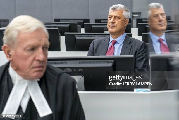 Kosovar former president Hashim Thaci sits with his lawyer David Hooper for the first time before a war crimes court in The Hague on November 9 to...