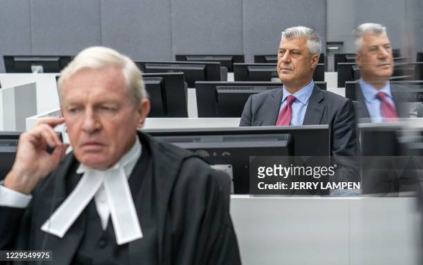Kosovar former president Hashim Thaci sits with his lawyer David Hooper for the first time before a war crimes court in The Hague on November 9 to...