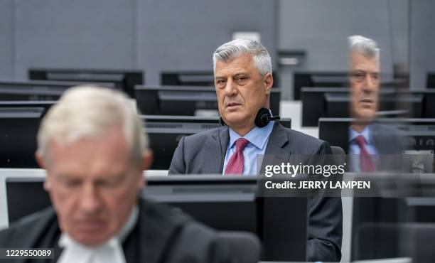 Kosovar former president Hashim Thaci sits with his lawyer David Hooper for the first time before a war crimes court in The Hague on November 9 to...