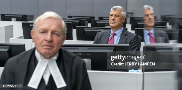 Kosovar former president Hashim Thaci sits with his lawyer David Hooper for the first time before a war crimes court in The Hague on November 9 to...