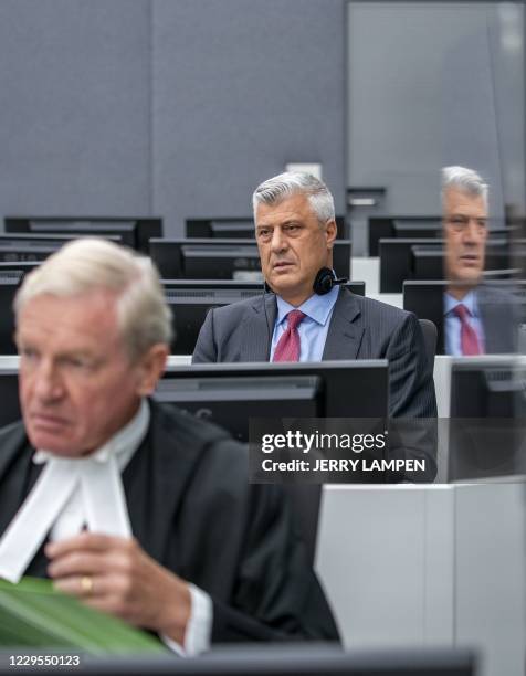 Kosovar former president Hashim Thaci sits with his lawyer David Hooper for the first time before a war crimes court in The Hague on November 9 to...