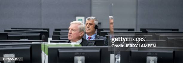 Kosovar former president Hashim Thaci sits with his lawyer David Hooper for the first time before a war crimes court in The Hague on November 9 to...