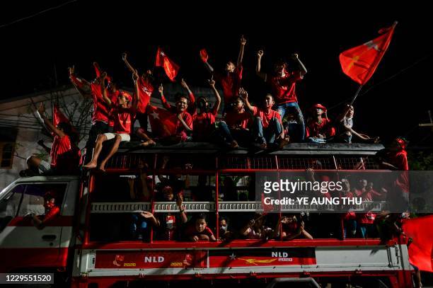 Supporters of the National League for Democracy party celebrate in Yangon on November 9 as NLD officials said they were confident of a landslide...