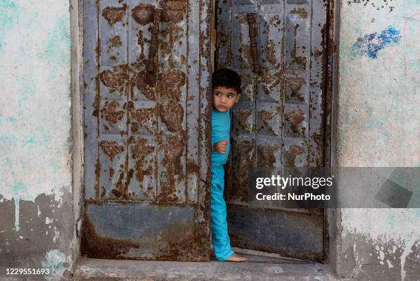 Palestinian boy looks out of his family house at Al-Shati refugee camp in Gaza City on November 9, 2020.