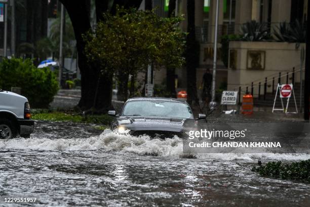 Car drives through the flooded street during heavy rain and wind as tropical storm Eta approaches the south of Florida, in Miami, Florida on November...